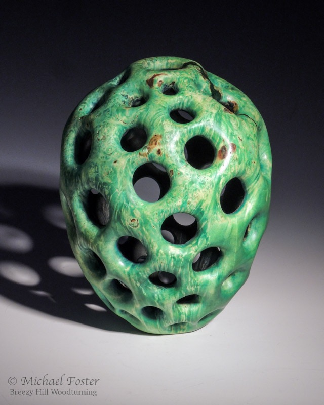 Perforated-  Turned wooden vessel carved with a Fibonacci arrangement of holes.  5 spirals in one direction and 8 in the other.----AVAILABLE