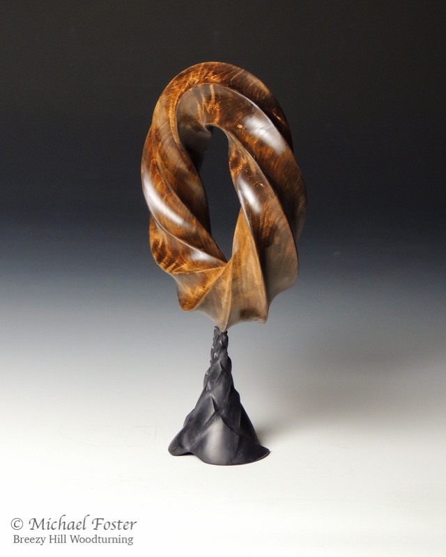 Fibonacci Torus-   A one sided (non-orientable) 8,5 torus knot.  The base is carved with opposing spirals, 3 in one direction, 5 in the other.----SOLD