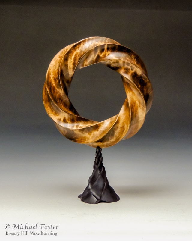 Fibonacci Torus-   Torus- Curly maple, stain, Bush oil,  7&rdquo; x 1.75&rdquo;.  Stand-  Maple, Leather dye, wax, 10.5&rdquo; tall with stand----SOLD