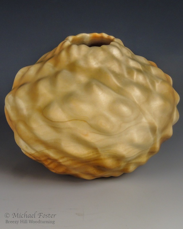 Parastichy II-   A vessel turned from Birch Burl with smooth lumps arranged in Fibonacci spirals with 13 in one direction and 8 in the other.----AVAILABLE