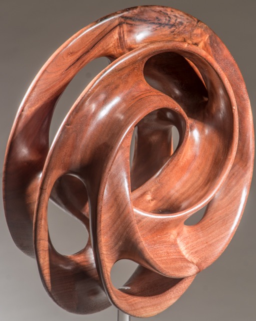 Convoluted-   Turned as a torus (donut) then carved to achieve the final form.  The only thing left of the surface of the torus is the edge of the carving.----SOLD
