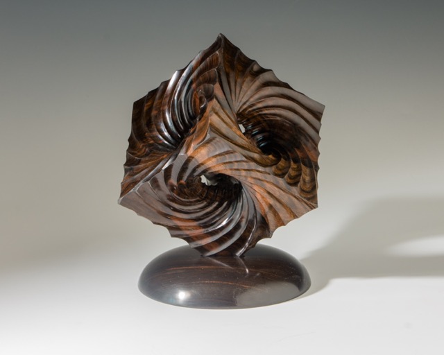Event Horizon-  A cube turned on the lathe on 6 axes.  Inward spirals inspired by the paths of matter and light as it approaches and is swallowed by a black hole---SOLD