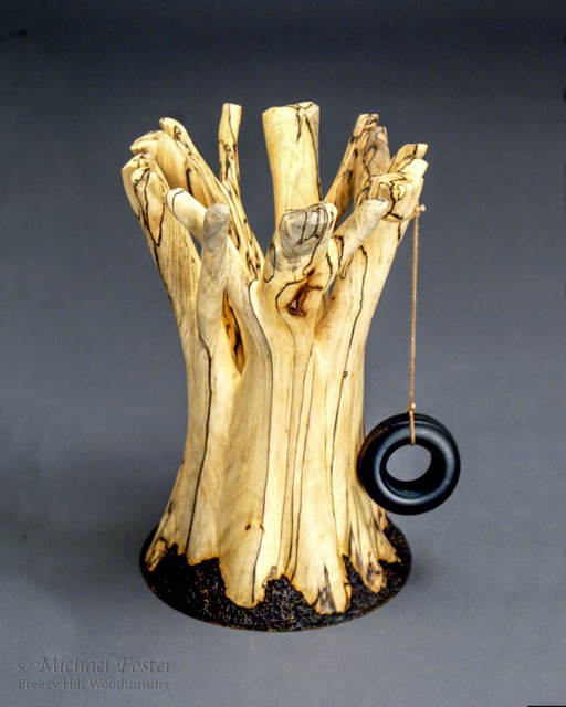 Geometree-   A piece turned from wood sent by John Jordan for Vicki Jordan&rsquo;s &ldquo;Beloved Tree&rdquo; project.  The form is a catenoid, and is meant to evoke the base of a tree.  Jordan maple,  5&rdquo;D x 7.5&rdquo;H, pyrography, lacquer, acrylic (tire) and string.----AVAILABLE