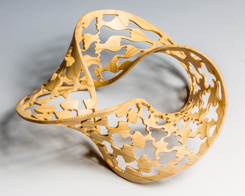 Escheresque-   This started as a turned torus (donut), that was then carved into a Mobius strip and subsequently pierced in a pattern inspired by MC Escher----SOLD