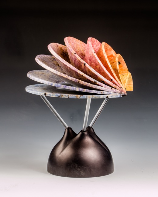 Conefluence-   In this piece nine separate conic sections merge together into the form of a hemisphere. Since the width of each conic section is the the same, the inner edges of the conic sections also describe a hemisphere.----SOLD